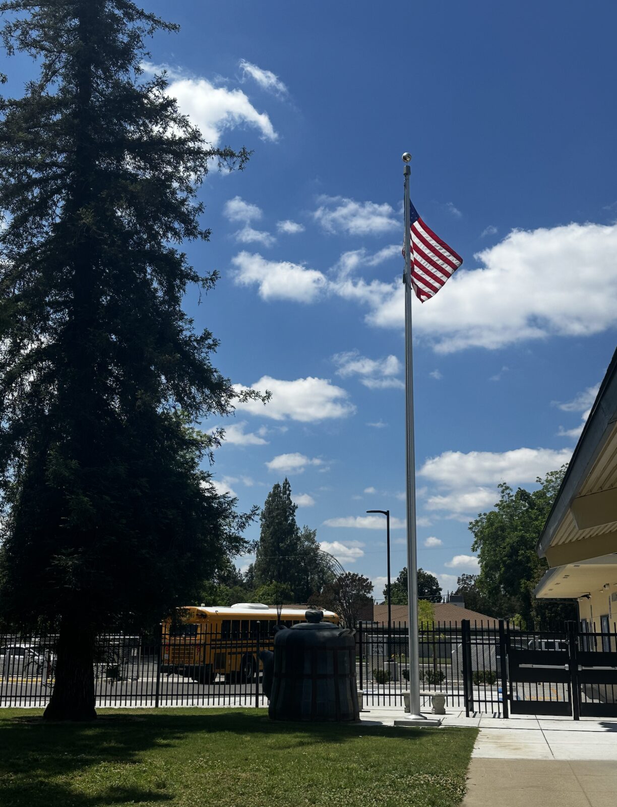 American flag on the flagpole in front of campus