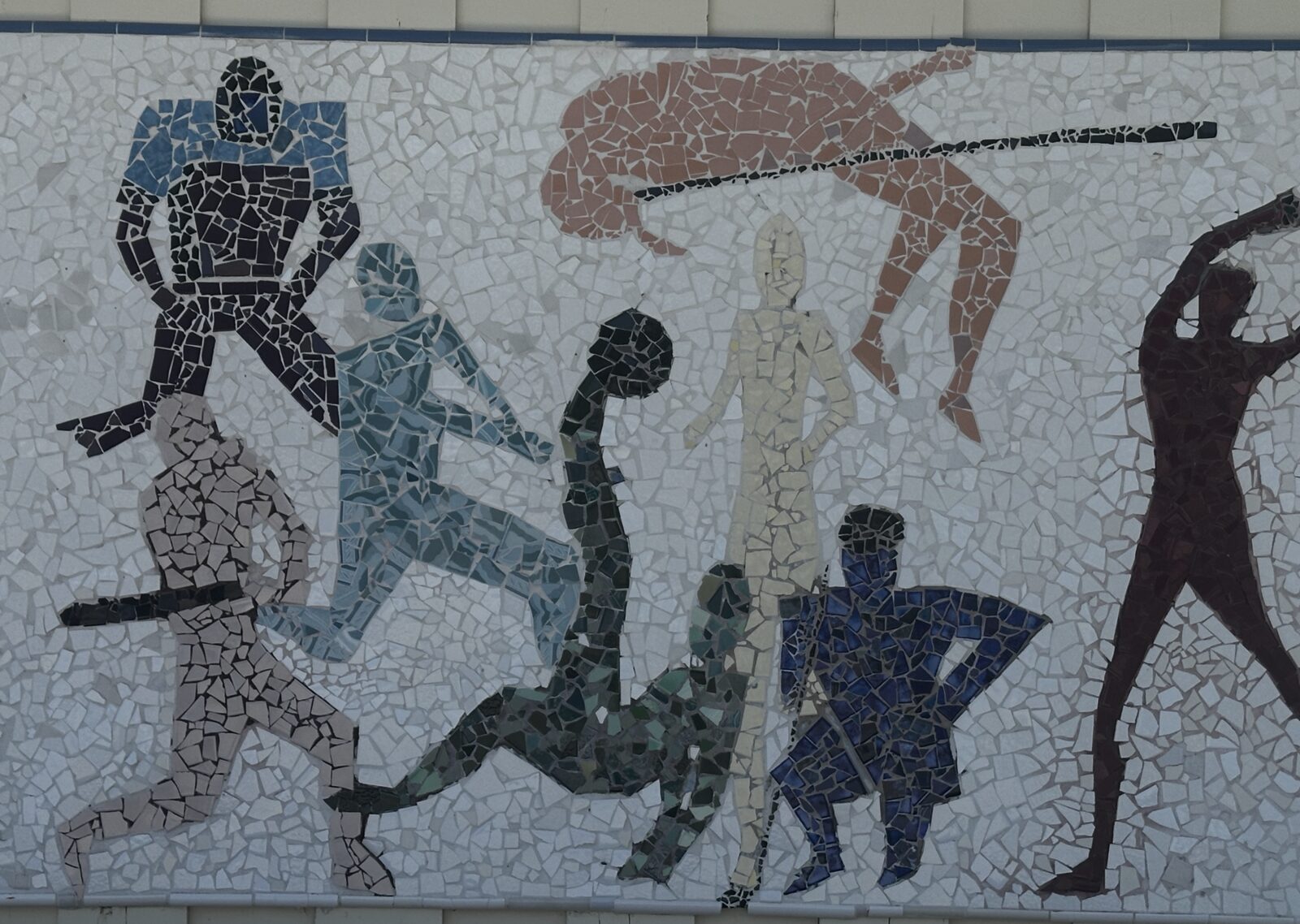 Student-made mosaic mural of athletes in motion